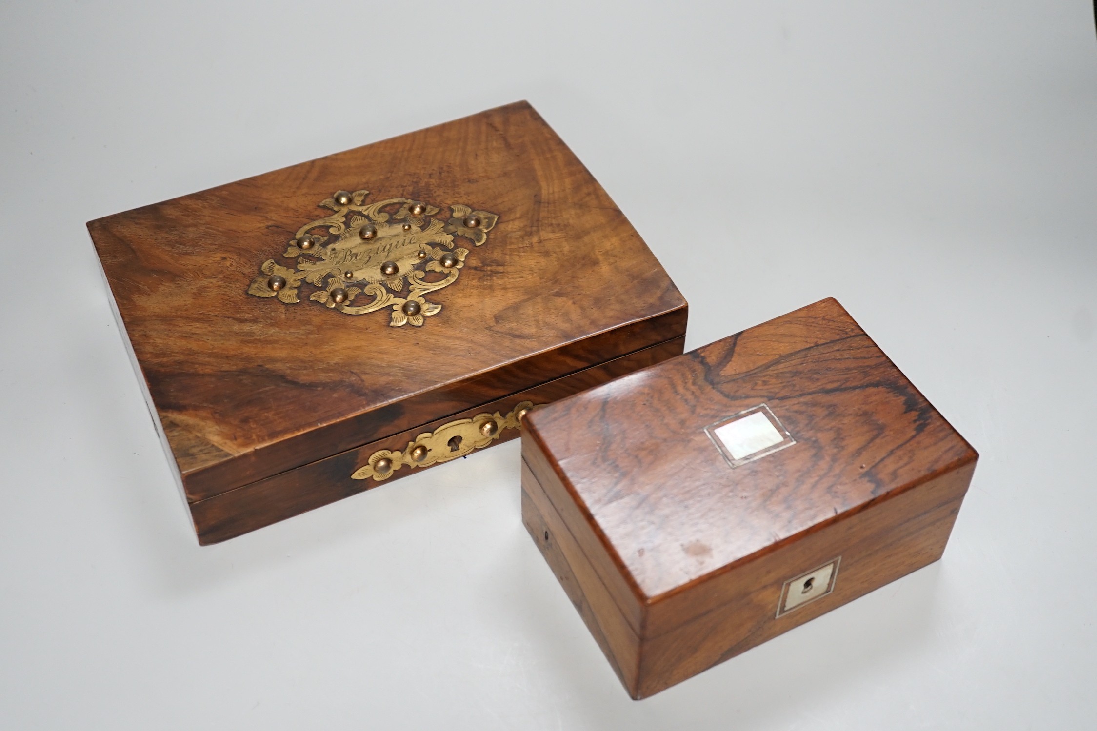 A Victorian walnut and brass 'Bezique' games box and a rosewood box. Largest 23cm wide